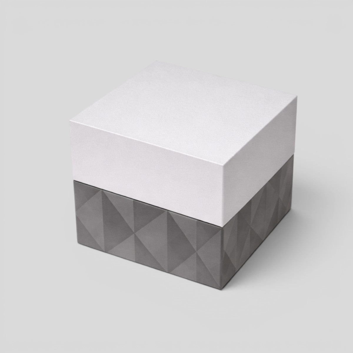 Stockka cubic jewelry box with removable lid, matte finish, grey textured base and silver top.