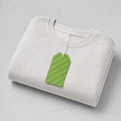 Stockka classic hang tag with green diagonal stripes, attached to a folded white sweatshirt.