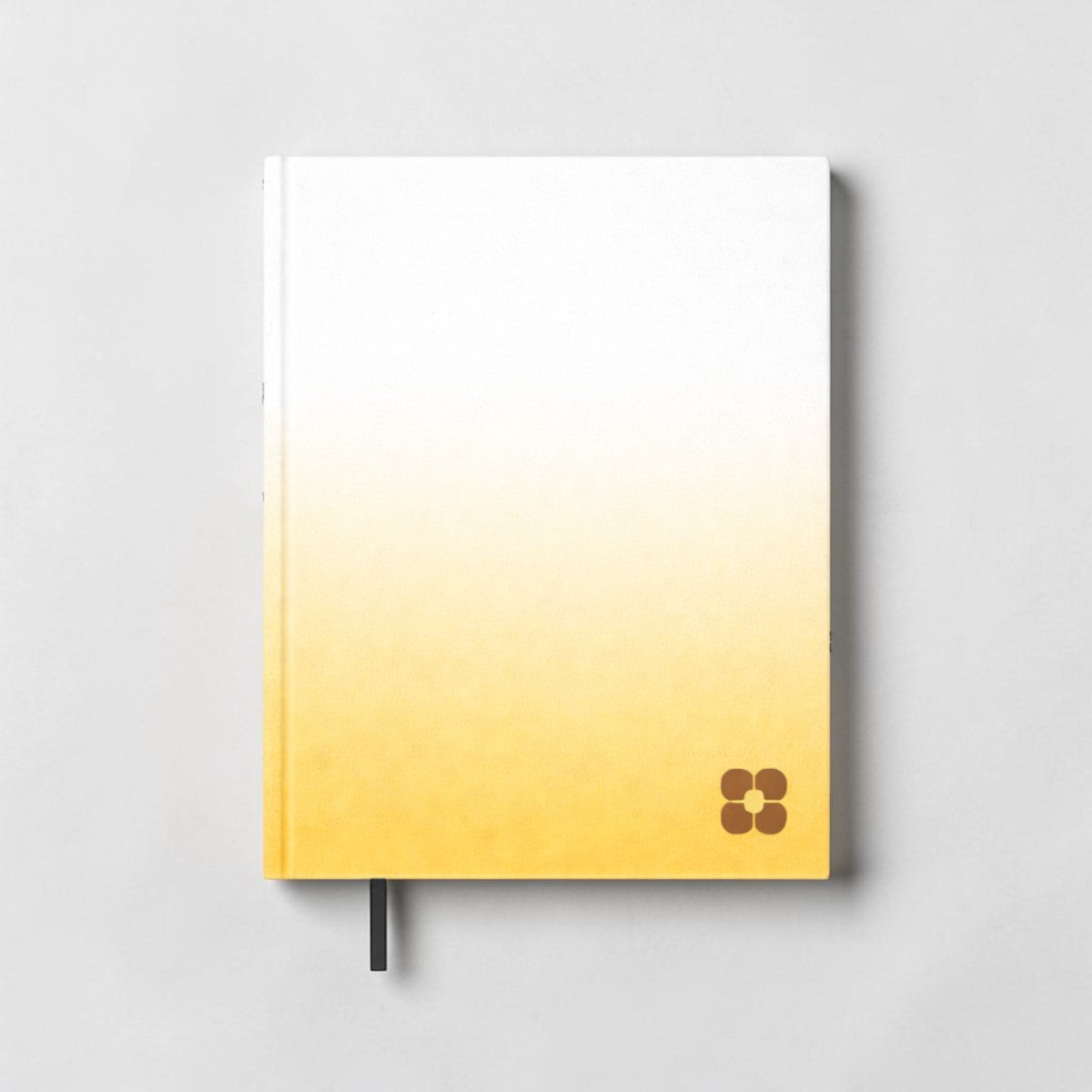 Stockka classic hard cover notebook with white to yellow gradient and brown flower logo. Features 80 lined pages and a bookmark.