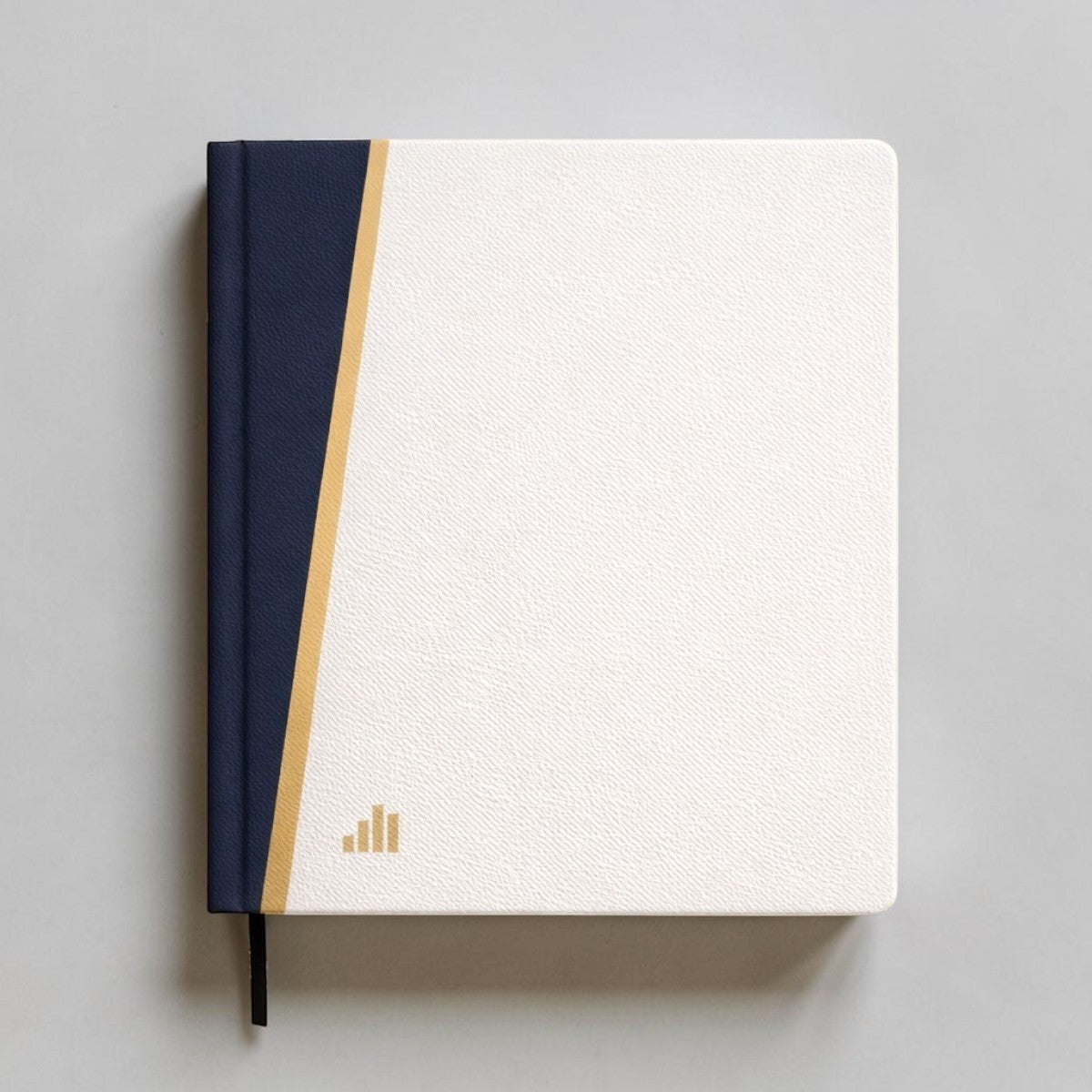 Stockka hard cover notebook with white textured cover, navy blue spine, and gold accent stripe. Features 80 lined pages and a bookmark.