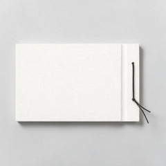 Stockka horizontal hard cover notebook with black string closure, 80 lined pages, customizable design.