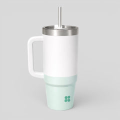 Stockka white and mint green insulated tumbler with handle and metal straw. Double-walled stainless steel construction.