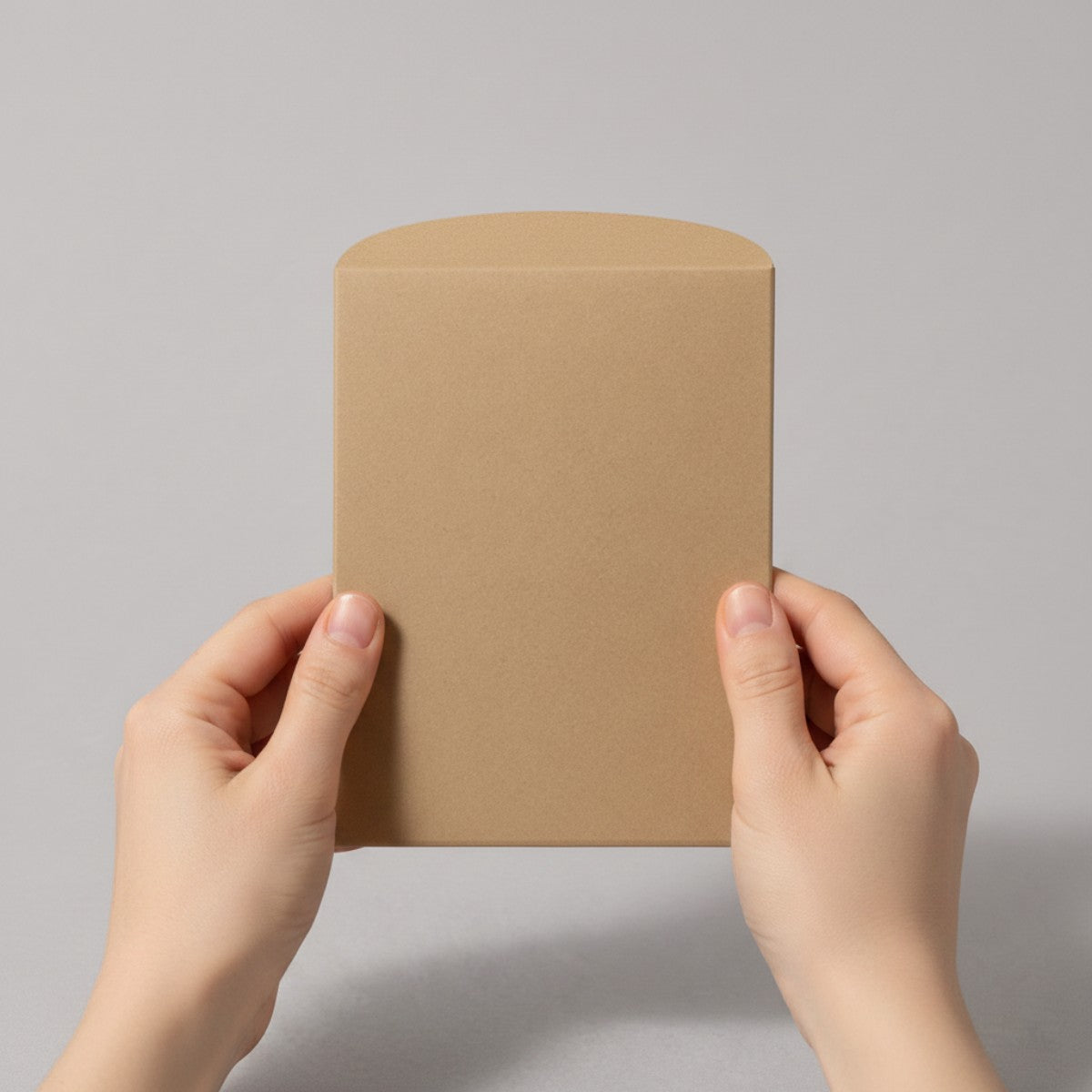 Stockka natural brown kraft paper envelope with curved closure, perfect for jewelry or small gifts.