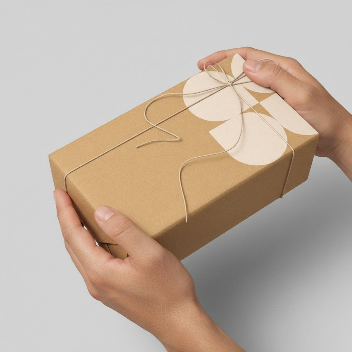 Stockka natural kraft cardboard gift box with twine tie and a cream floral design. Rectangular box, ideal for small items or lifestyle products.