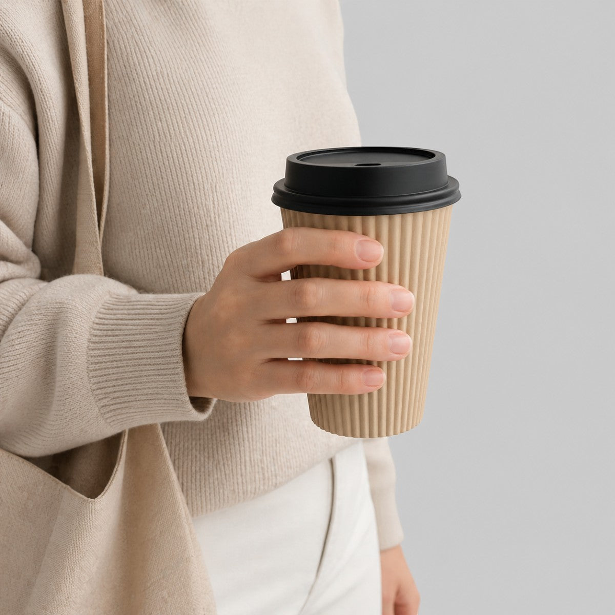 Stockka corrugated kraft paper cup with black lid, perfect for hot beverages like coffee or tea.