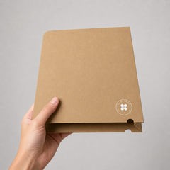 Stockka natural kraft paper document folder with a semi-circle thumb cut for easy access, held in a hand.