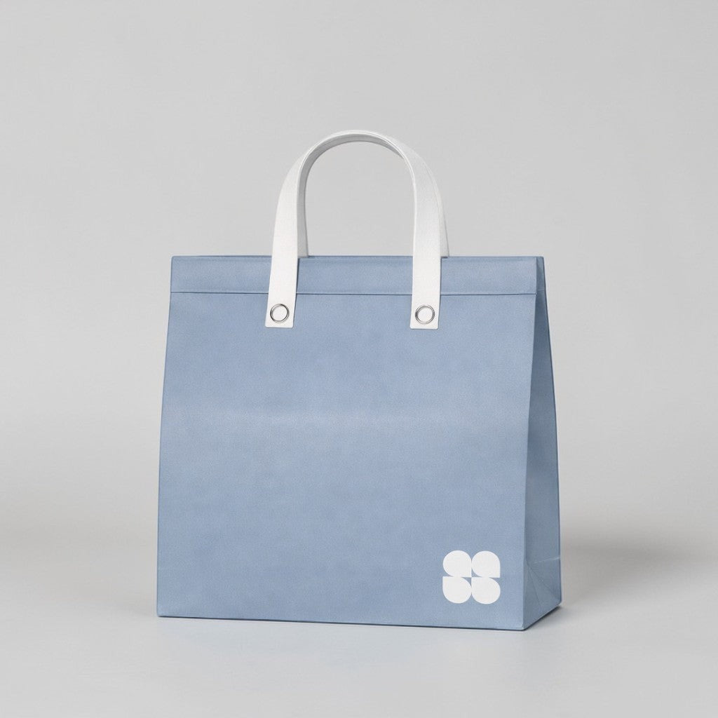 Stockka large light blue non-woven polypropylene tote bag with white reinforced handles and a subtle logo.