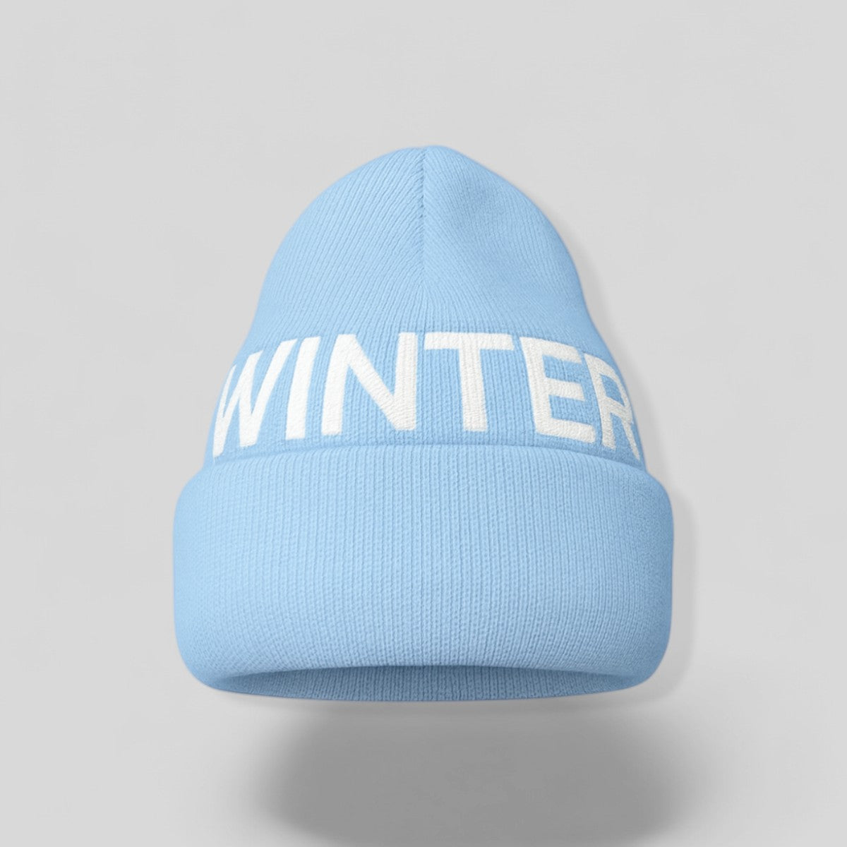Stockka light blue acrylic knit beanie with white "WINTER" text, double knit for warmth.