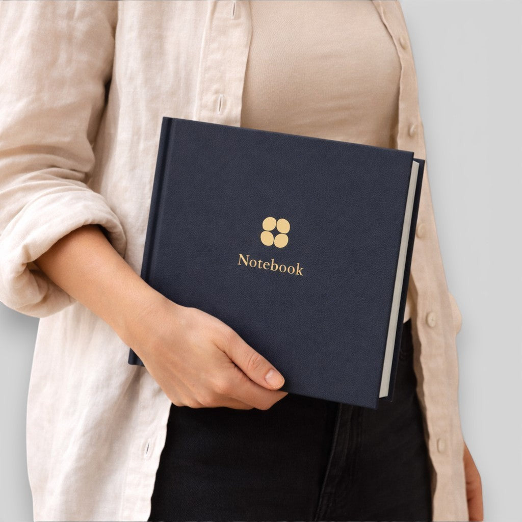 Stockka navy blue hard cover notebook with gold logo and text, 80 lined pages, customisable design.