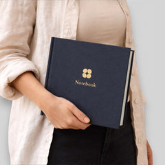 Stockka navy blue hard cover notebook with gold logo and text, 80 lined pages, customisable design.