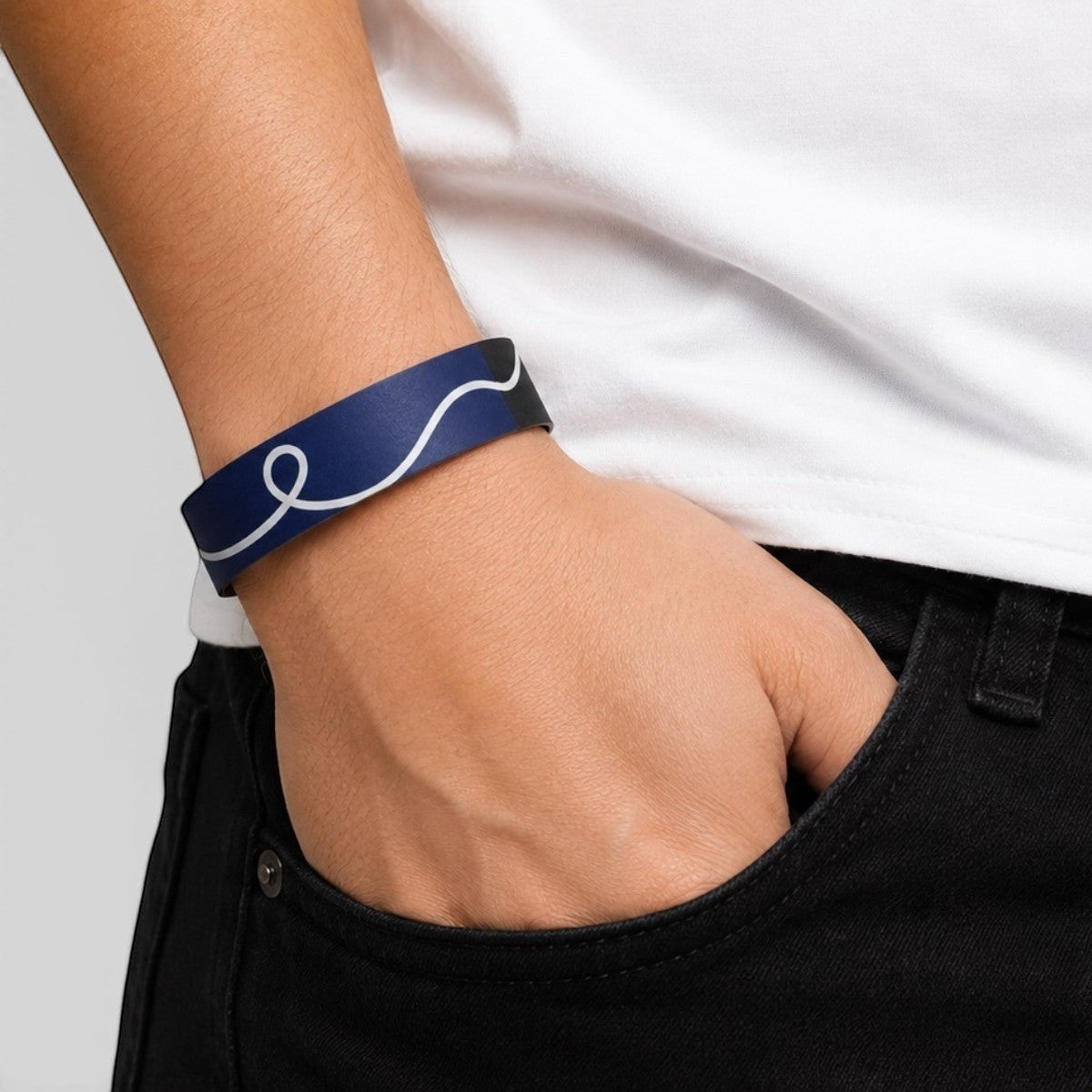 Stockka navy blue paper wristband with white swirl design and adhesive closure, for events and festivals.