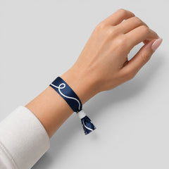Stockka navy blue polyester wristband with white swirl design and plastic clasp. Ideal for events.