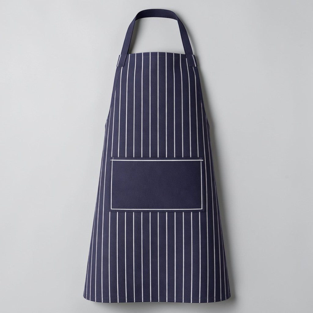 Stockka navy blue and white striped full-length apron with adjustable neck strap and front pocket. Cotton-polyester blend.