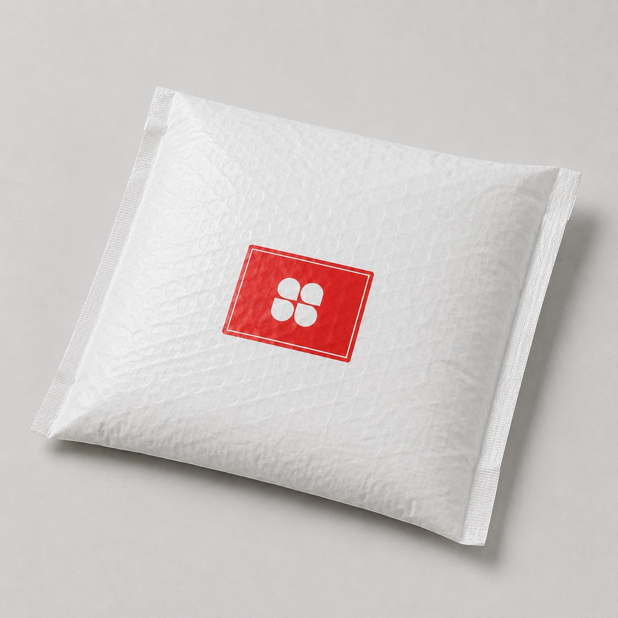 Stockka white padded envelope with red and white logo, ideal for shipping and packaging.
