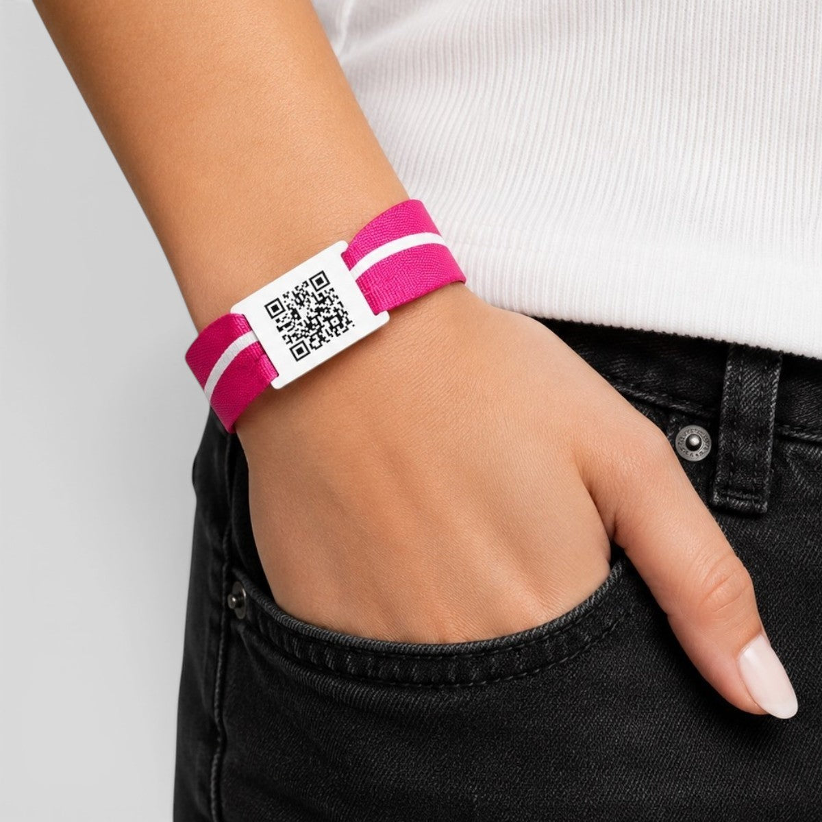Stockka pink polyester wristband with white stripes and a PVC card featuring a QR code for digital access.