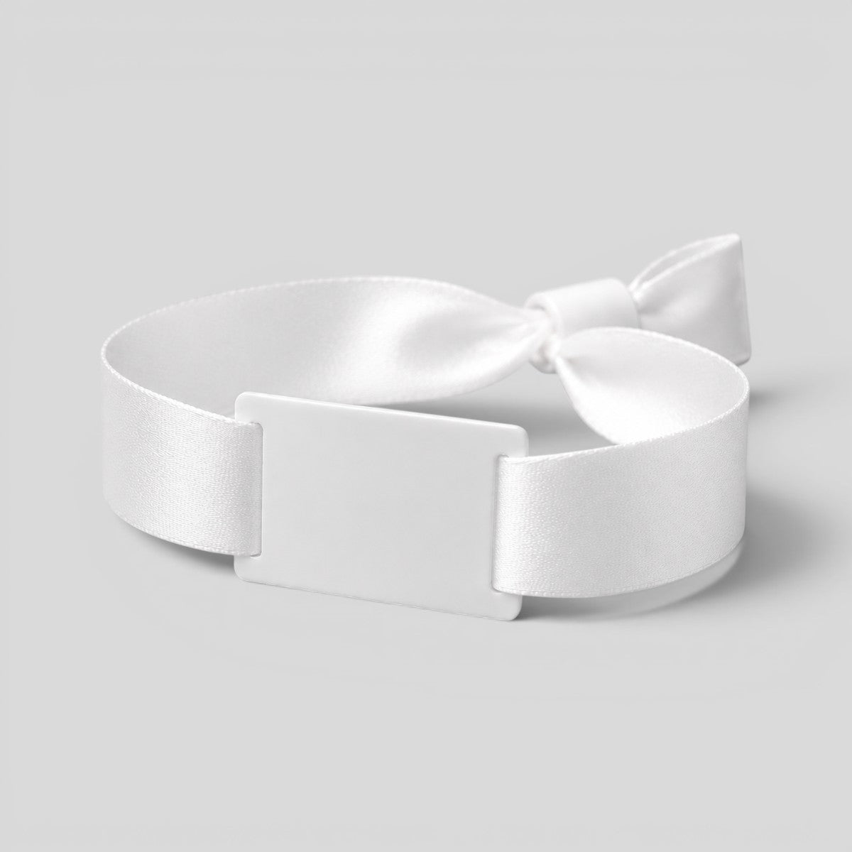 Stockka white polyester fabric wristband with PVC tag and plastic closure, ideal for events and festivals.