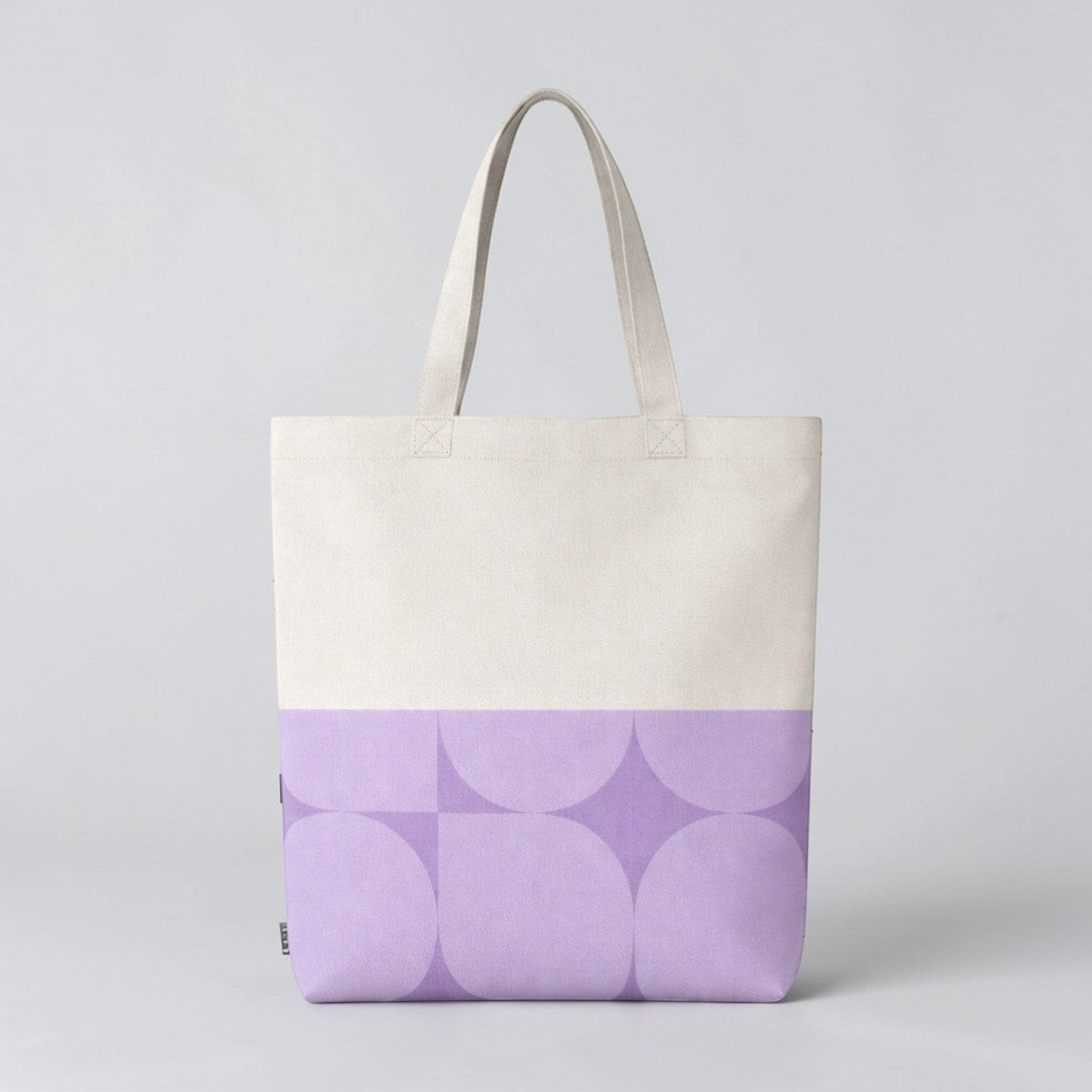 Stockka natural cotton canvas tote bag with a geometric purple pattern on the bottom half. Ideal for everyday use or custom branding.