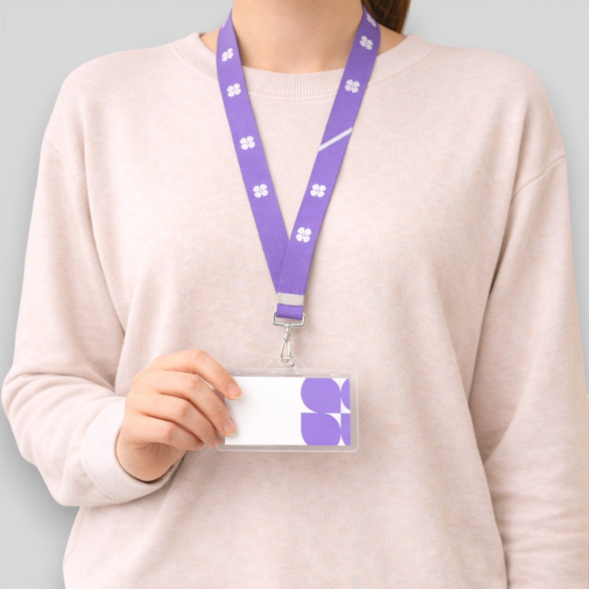 Stockka purple polyester lanyard with white flower pattern and clear ID card holder.