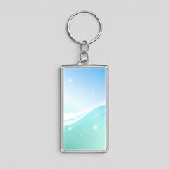 Stockka rectangular acrylic keychain with silver metal ring, featuring a blue and green gradient with white waves and sparkles.