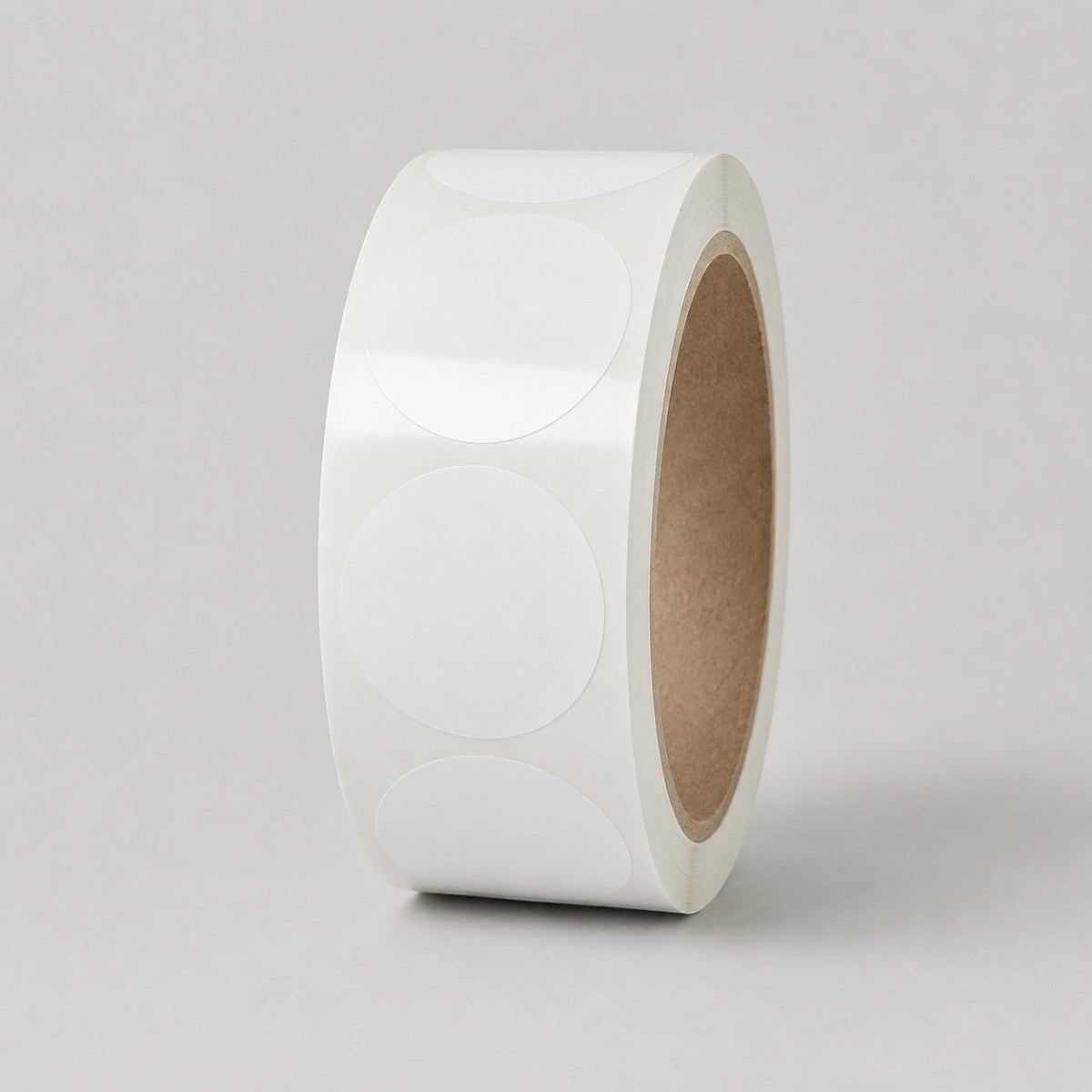 Stockka roll of blank white round stickers, perfect for custom branding on products, packaging, and shipping.