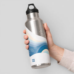 Stockka silver metal water bottle with blue wave design and black cap, featuring a convenient carry handle.