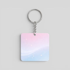 Stockka square acrylic keychain with a pastel pink and blue gradient, featuring subtle sparkles and a silver metal chain.