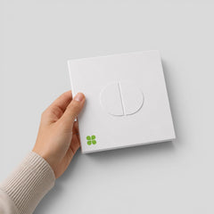 Stockka square white matte cardboard envelope with integral tab closure held in a hand for premium invitations.