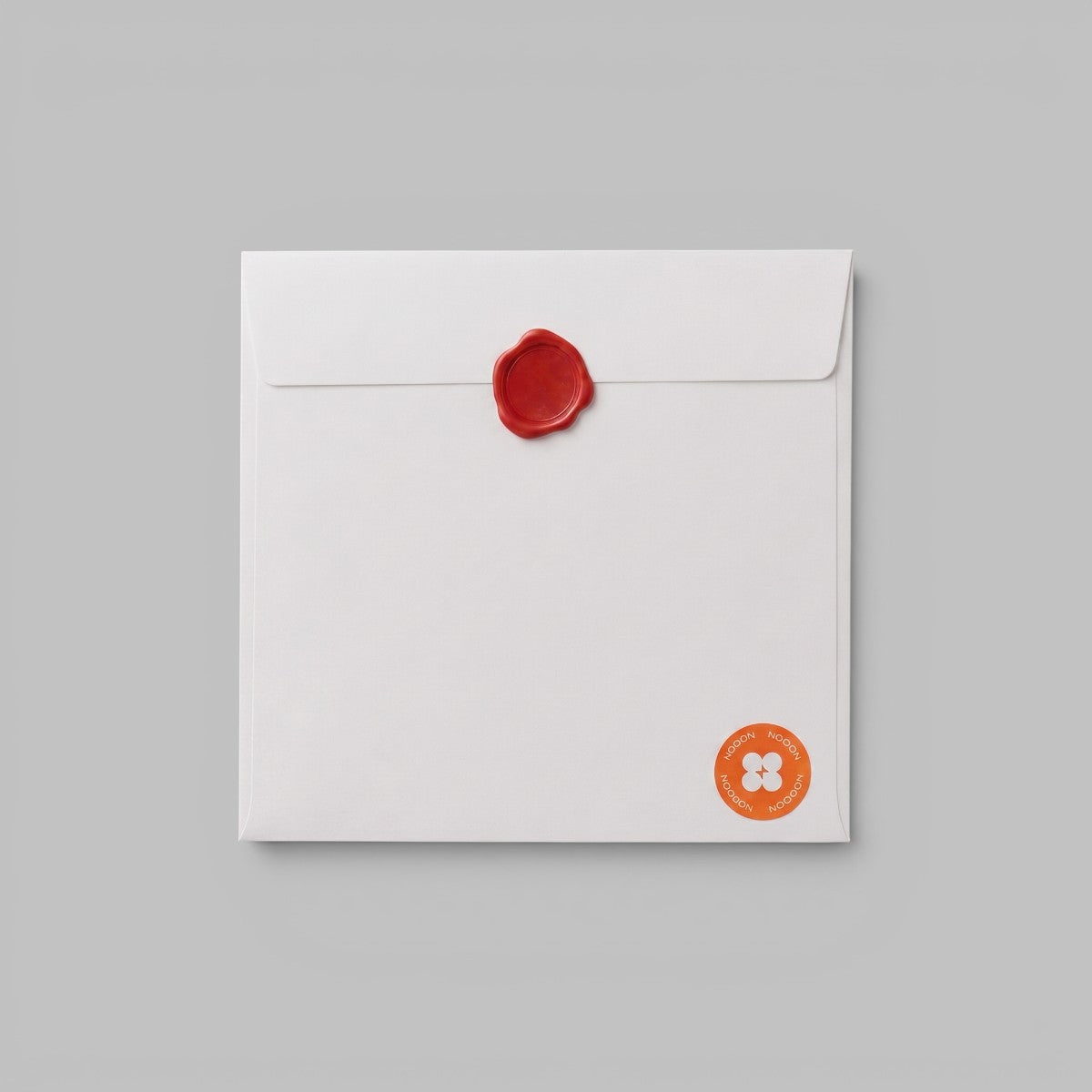 Stockka white square envelope made of 250gsm wood-free paper with a red wax seal for formal invitations.