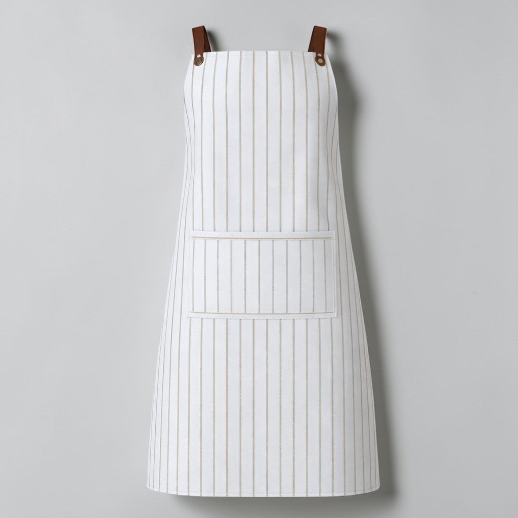 Stockka white and beige striped full-length apron with large front pocket and adjustable straps. Cotton-polyester blend.