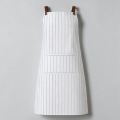 Stockka white and beige striped full-length apron with large front pocket and adjustable straps. Cotton-polyester blend.
