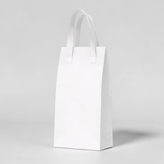 Stockka tall white kraft paper take-out bag with handles, ideal for bottles and premium deliveries.