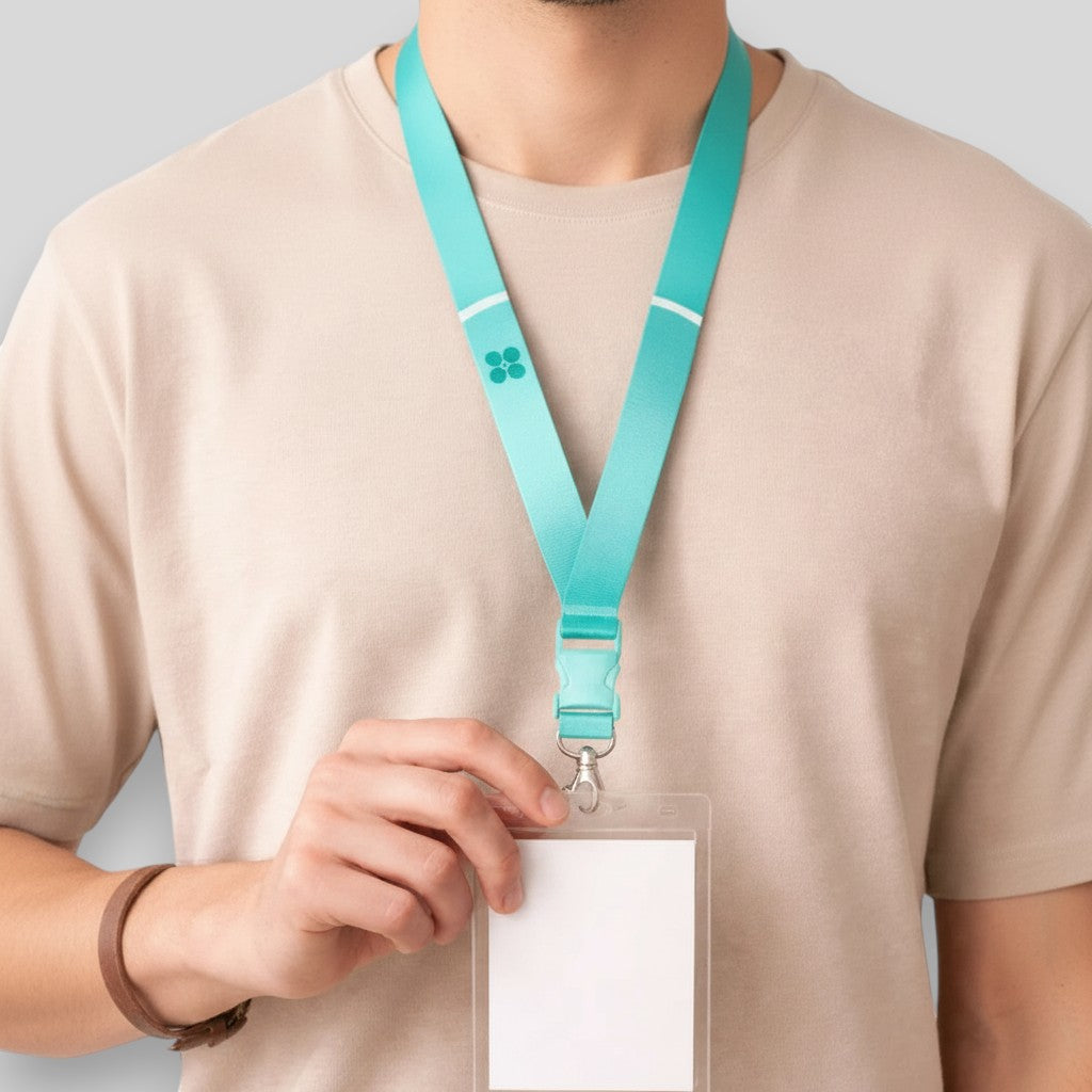 Stockka teal V-neck lanyard with detachable buckle and metal clip, made of polyester. Ideal for official events.