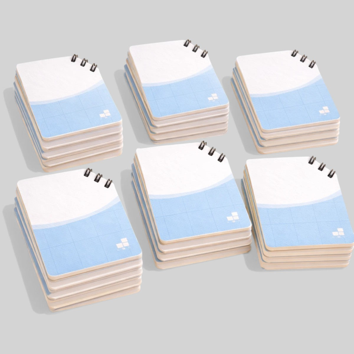 Stockka top spiral notebook with light blue grid design and 80 lined pages, soft cover.