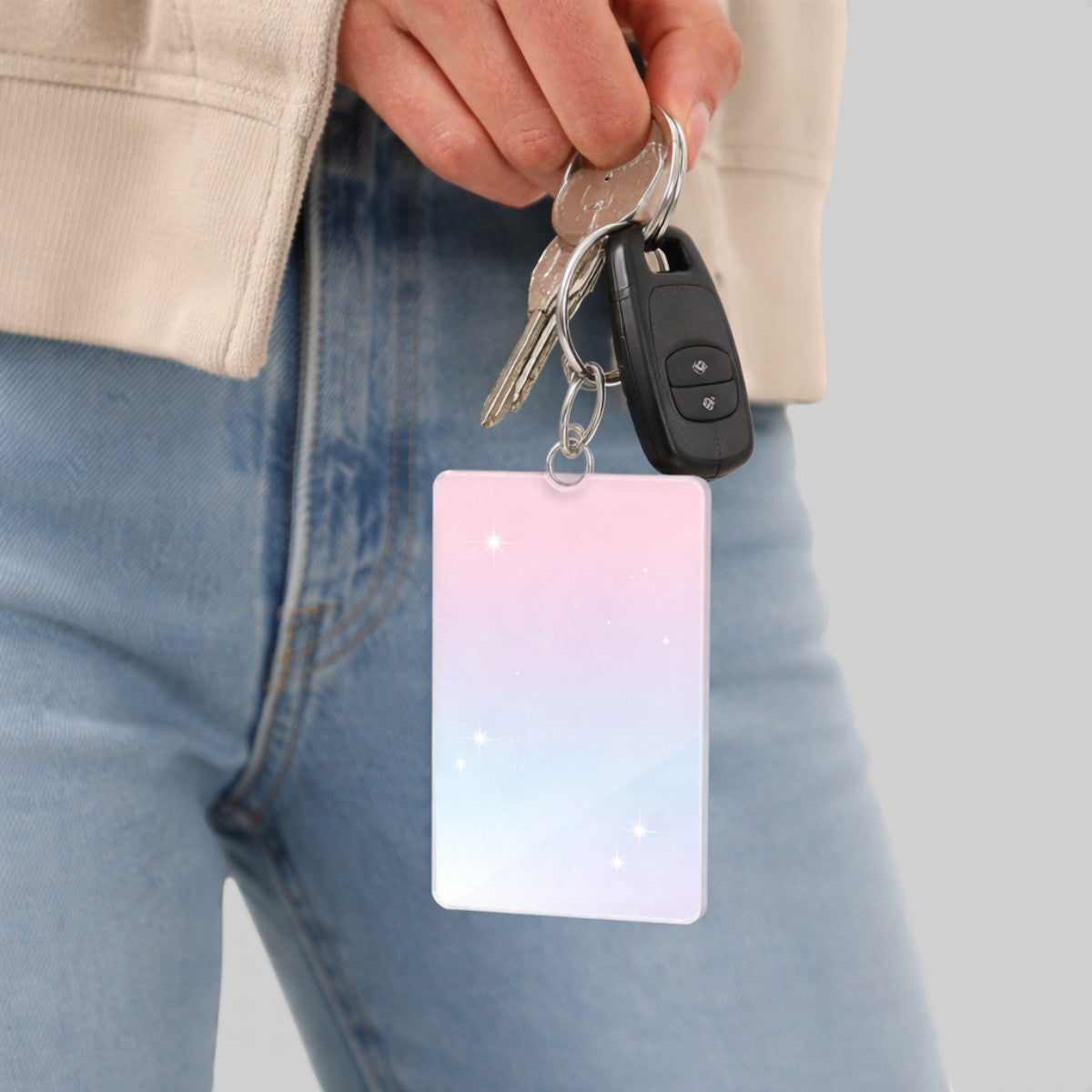 Stockka vertical acrylic keychain with a pastel pink to blue gradient and sparkling stars, attached to keys.