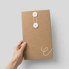 Stockka vertical brown kraft paper envelope with white string and disc closure for documents and marketing materials.