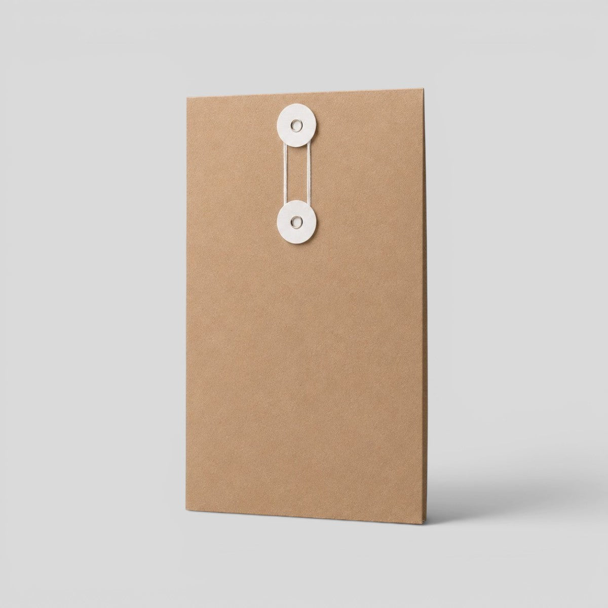 Stockka vertical brown kraft paper envelope with white string and disc closure, ideal for documents and contracts.