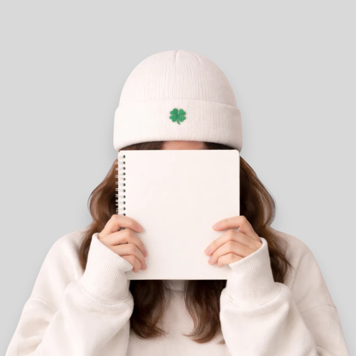 Stockka white acrylic knit beanie with a green clover detail. Double knit for warmth.