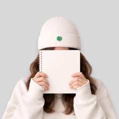 Stockka white acrylic knit beanie with a green clover detail. Double knit for warmth.