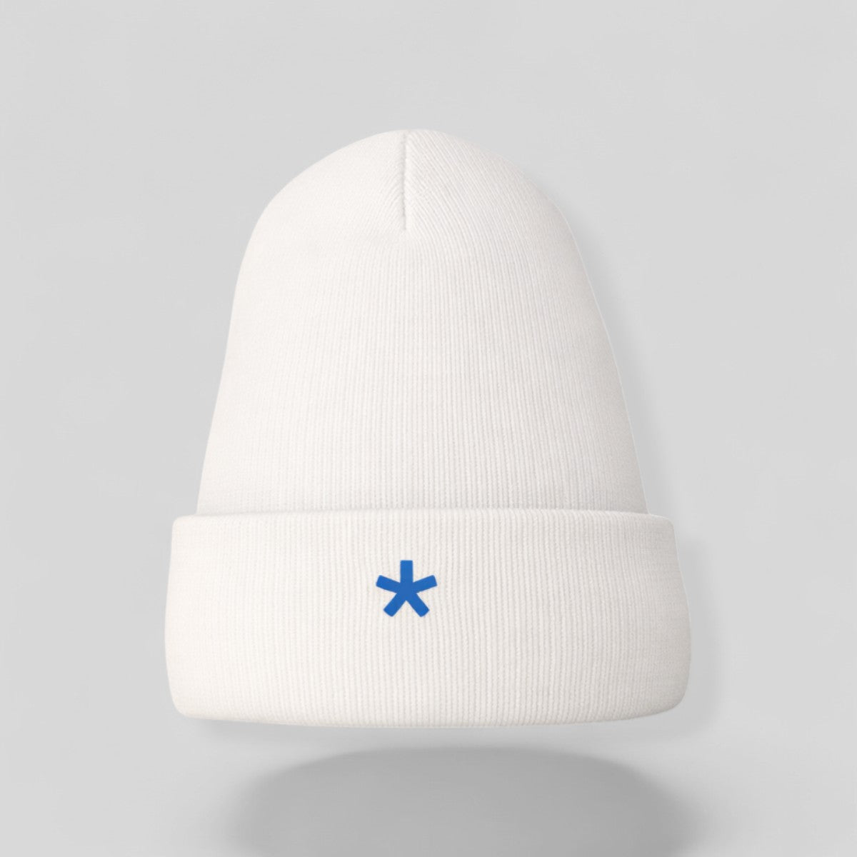 Stockka white acrylic knit beanie with a folded brim and a small blue asterisk logo.