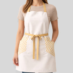 Stockka white full-length apron with yellow wave pattern side pockets and adjustable neck strap.