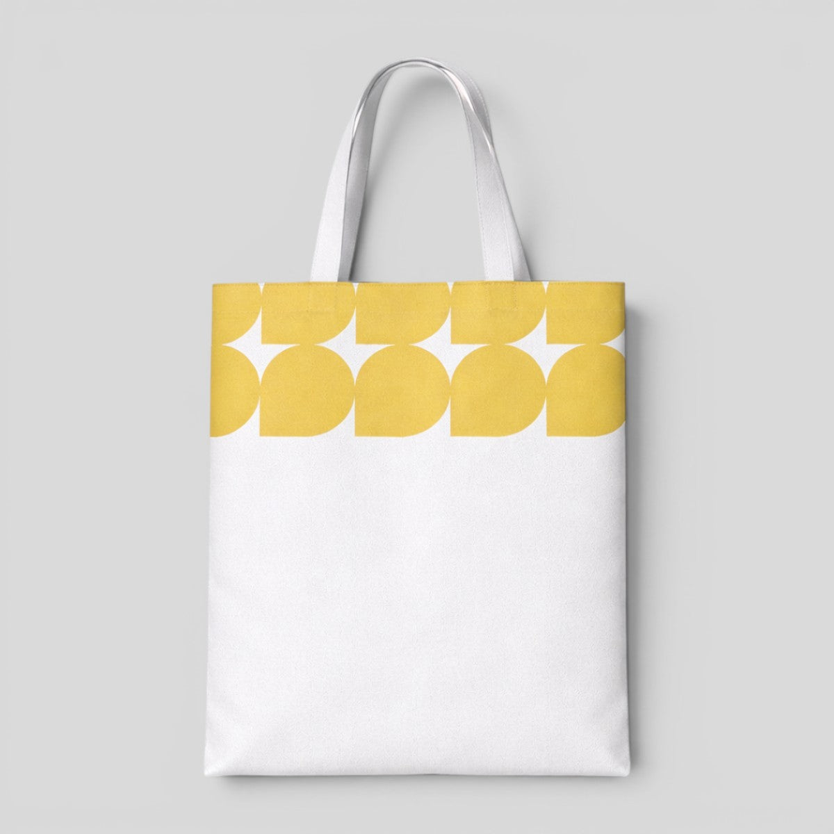 Stockka white canvas tote bag with a yellow abstract leaf pattern at the top. Made of 100% cotton.