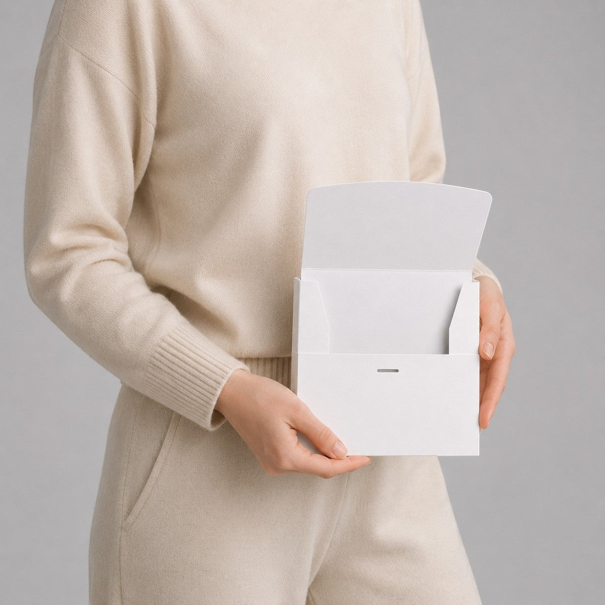 Stockka white matte coated cardboard envelope with front opening and internal tabs for secure closure.
