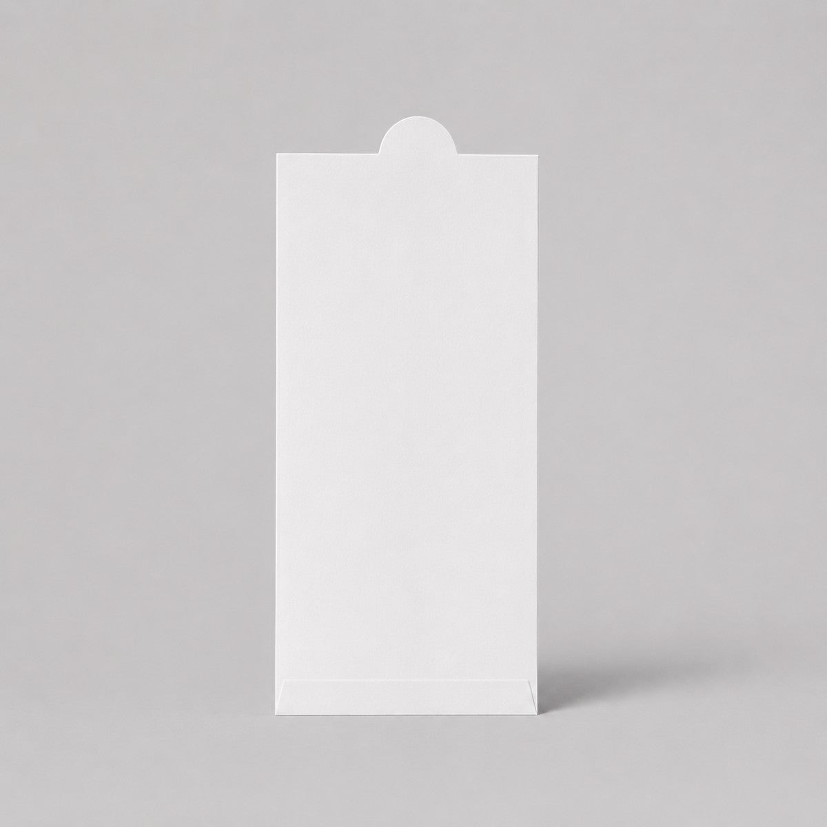 Stockka vertical white matte cardboard envelope with rounded tab closure for gift certificates, cards, or narrow documents.