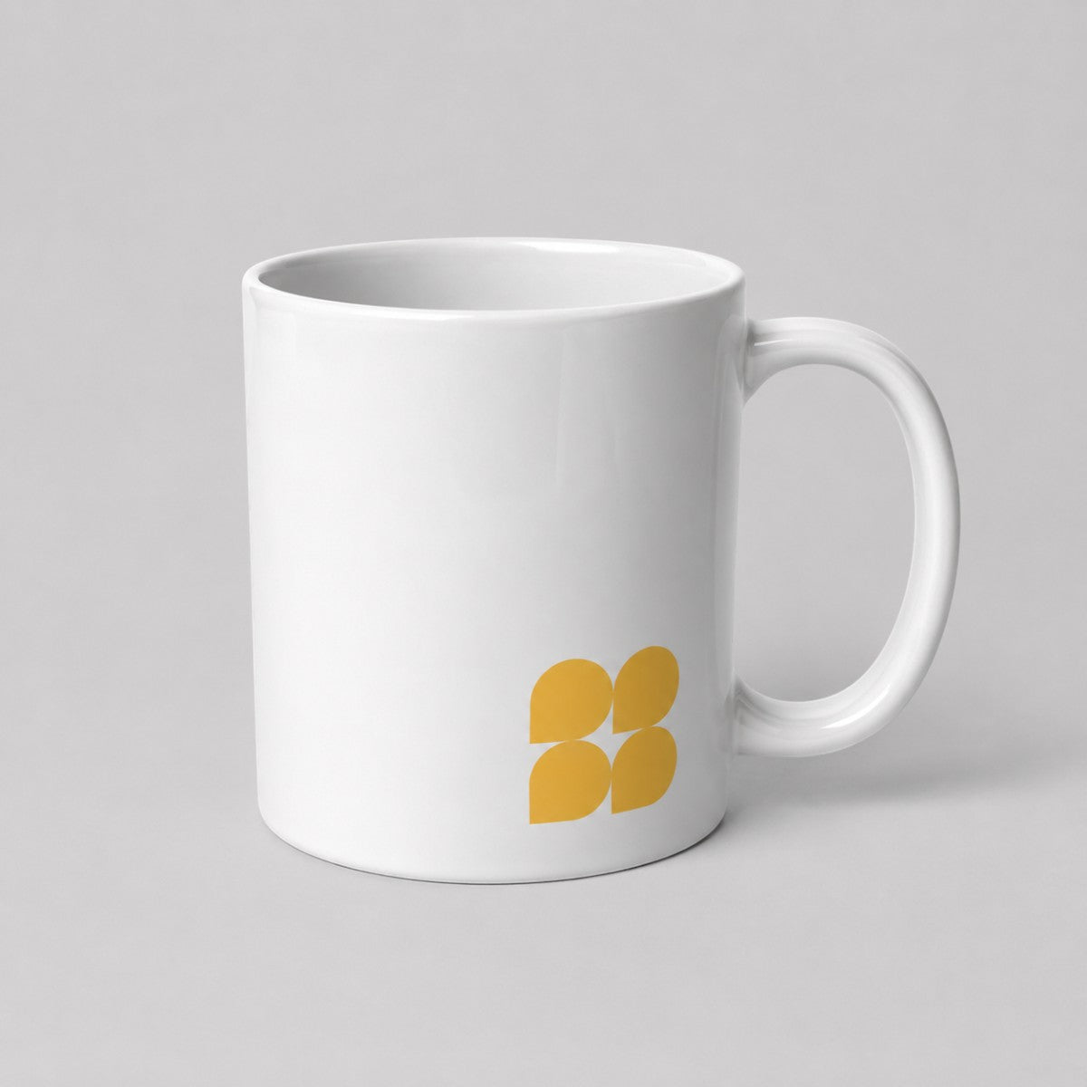 Stockka classic white ceramic mug with a yellow four-petal logo, 325ml capacity and comfortable handle.