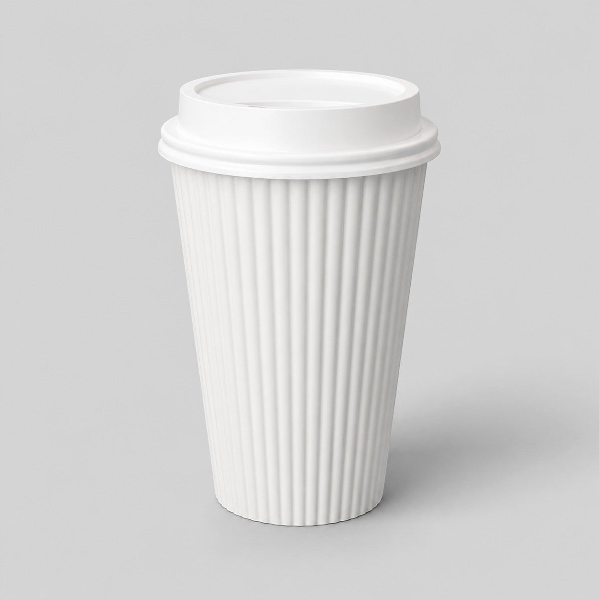 Stockka white corrugated paper coffee cup with a black plastic lid, perfect for hot beverages.