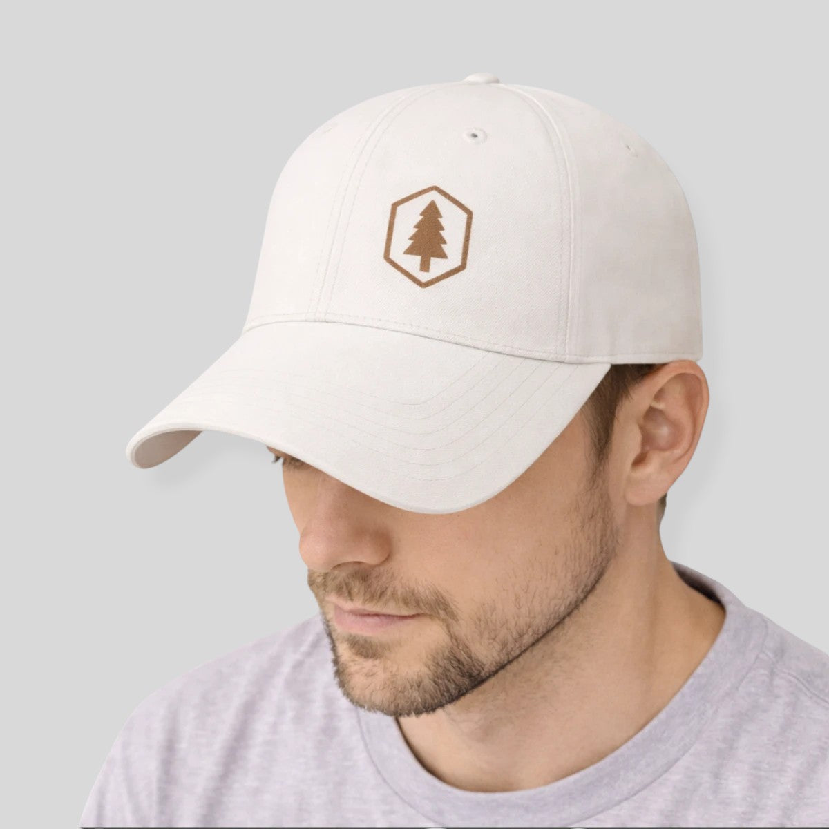 Stockka white cotton twill baseball cap with adjustable velcro closure and embroidered tree logo.