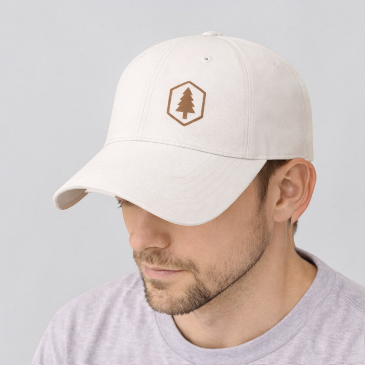 Stockka white cotton twill baseball cap with adjustable plastic closure and embroidered tree logo.