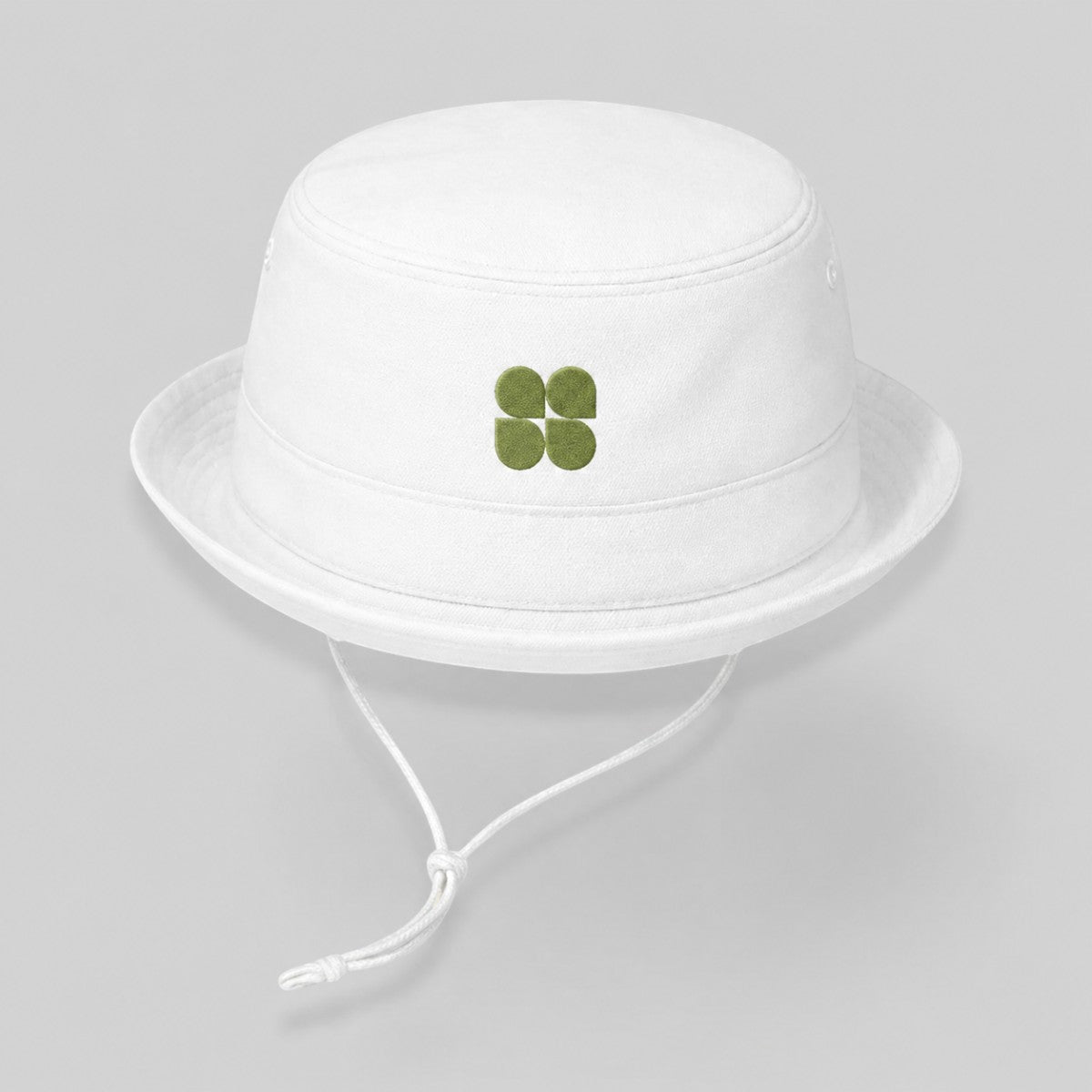 Stockka white cotton bucket hat with green clover logo and adjustable chin strap, ideal for outdoor activities.