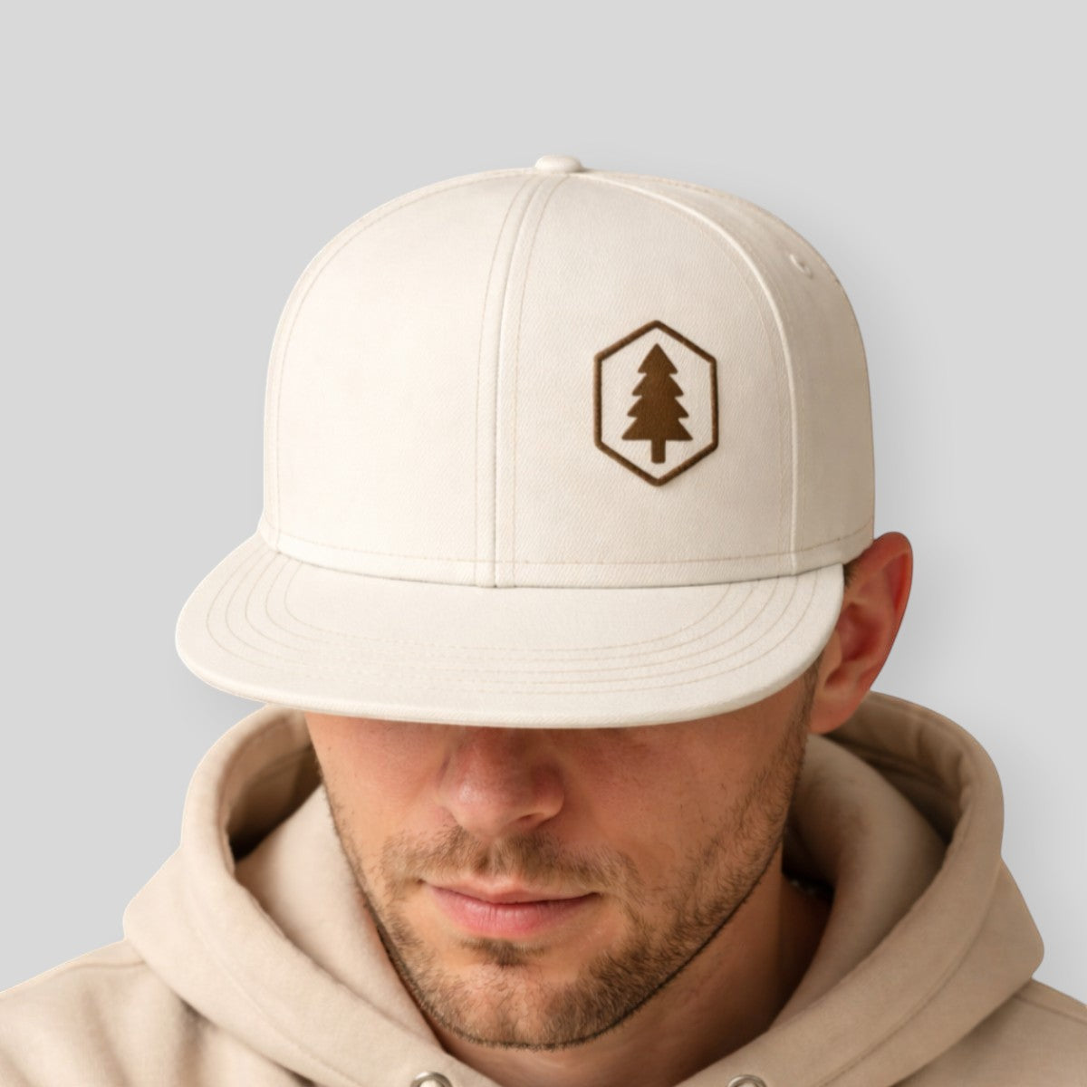 Stockka white cotton snapback hat with flat brim and embroidered tree logo. Adjustable back closure.