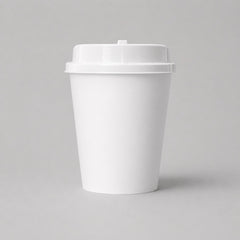 Stockka white double-walled paper coffee cup with kraft sleeve and white lid, ideal for hot beverages.